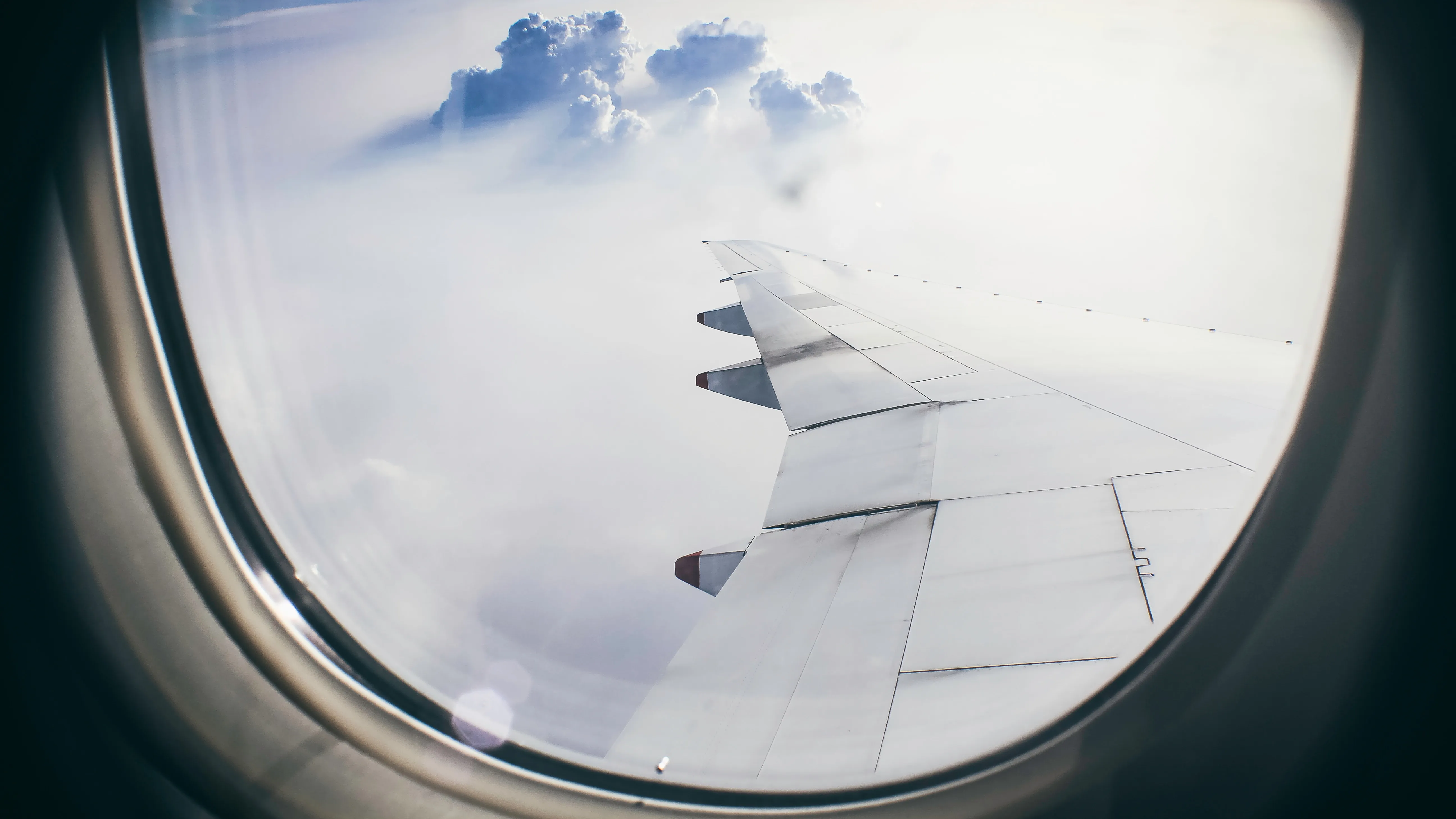 Plane wing over clouds